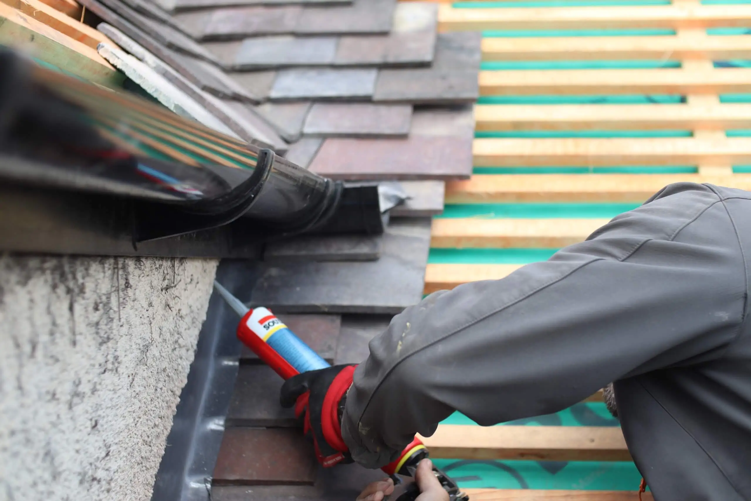 Roofer Applying sealant over the lead